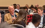 man speaking at the summit