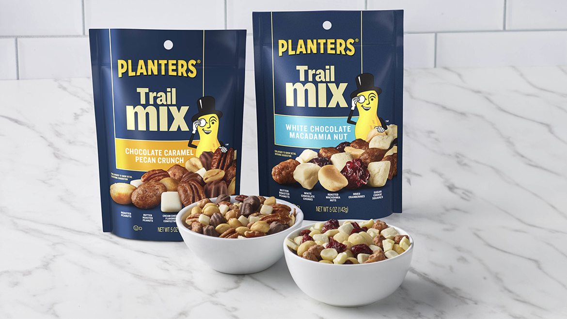 Pouches and bowls of Planters Trail Mix on counter