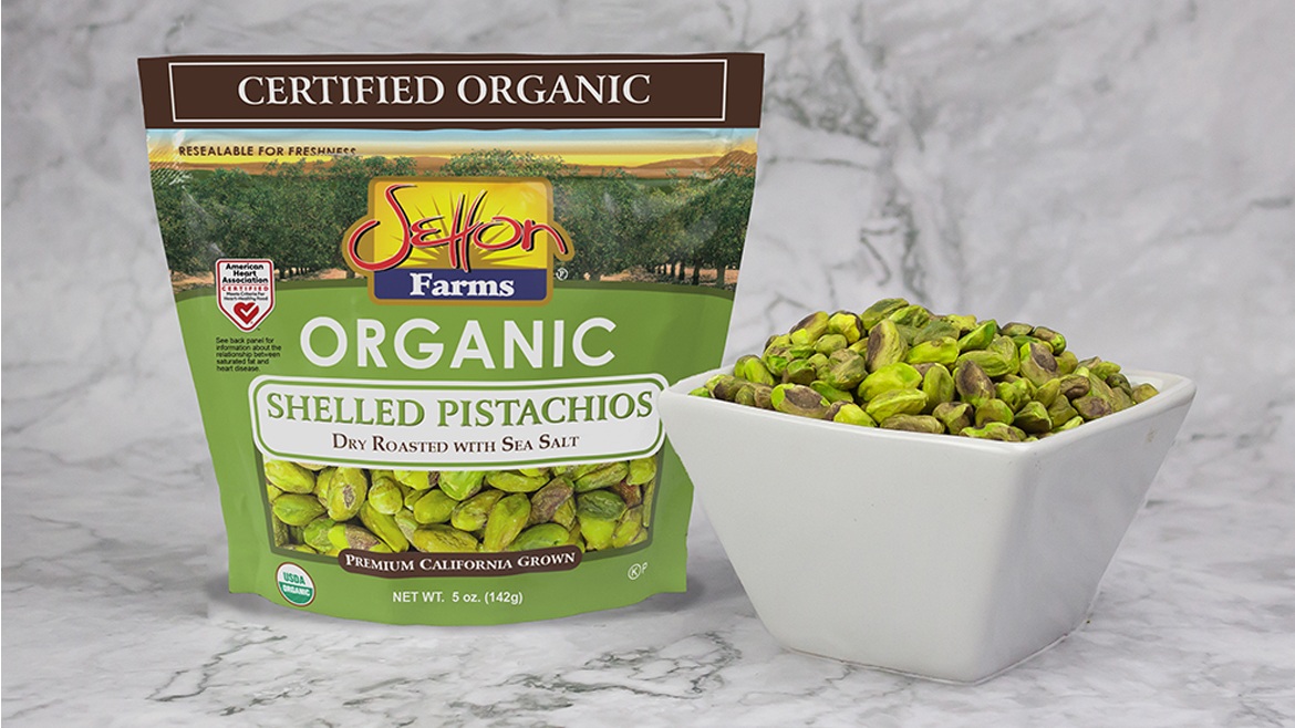 Pouch and bowl of Setton Farms Organic Shelled Pistachios on counter