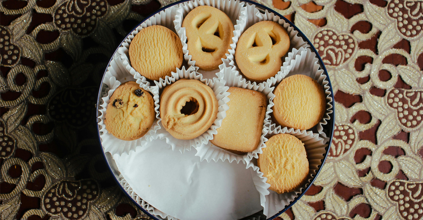 Tin of butter cookies on table