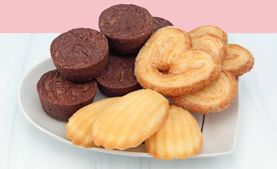 Madeleines, palmiers, and other baked goods on a table