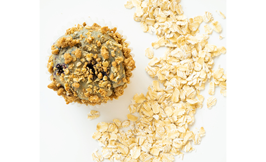 Blueberry muffin next to pile of oats