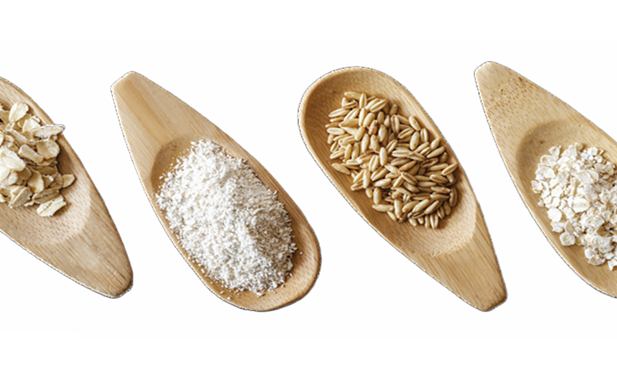 Four wooden spoons filled with different kinds of oats