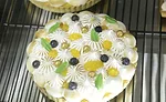 A pie with nonpareils on the top and leaf-shaped adornments.