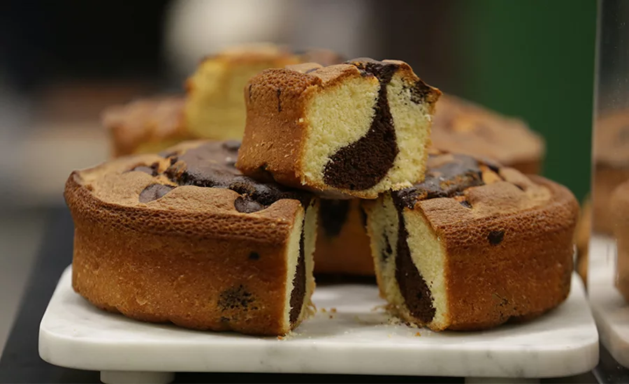 A cake with chocolate in the middle of it and with a brown crust.