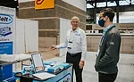 an interaction at a trade show or expo booth