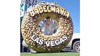 Woman hiding behind giant bagel-shaped Siegel’s Bagelmania sign
