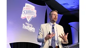 a speaker presenting at a conference focused on food safety protocols and industry advancements. 