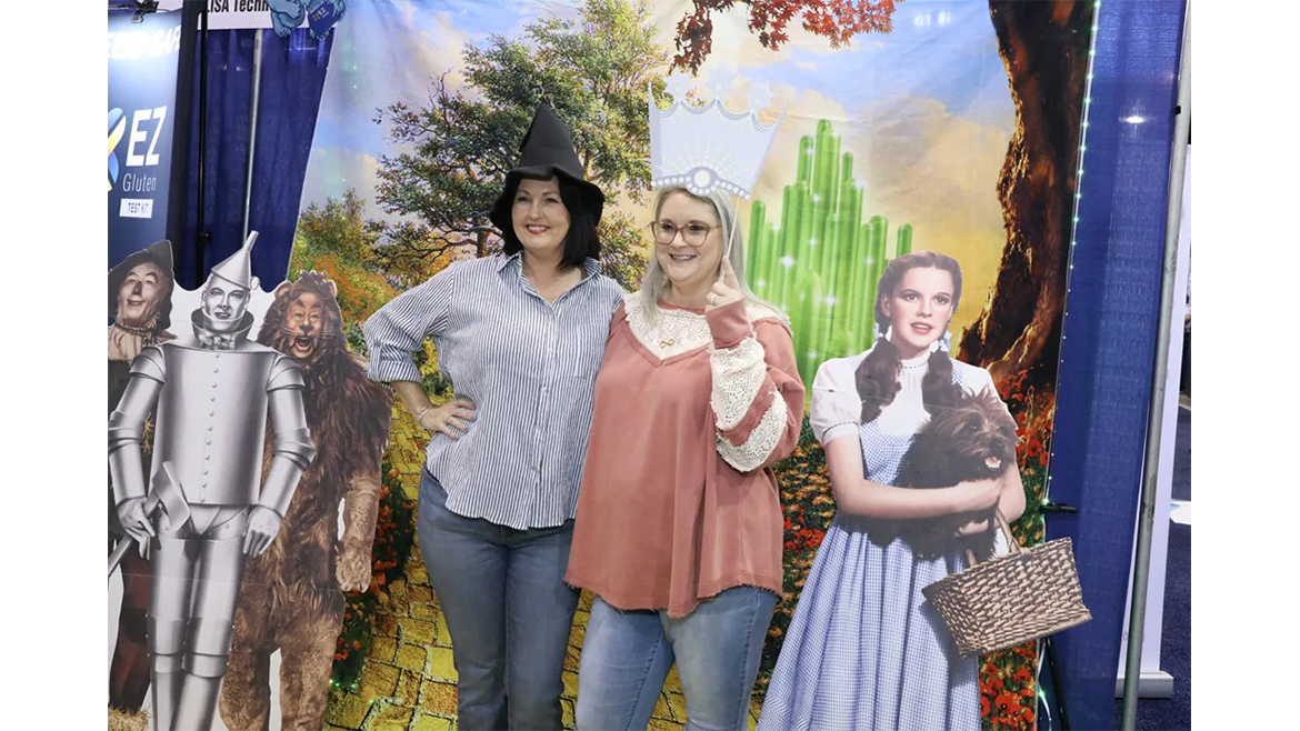 Two women in front of cutouts from The Wizard of Oz