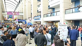 This image shows a large crowd attending a major trade show event.