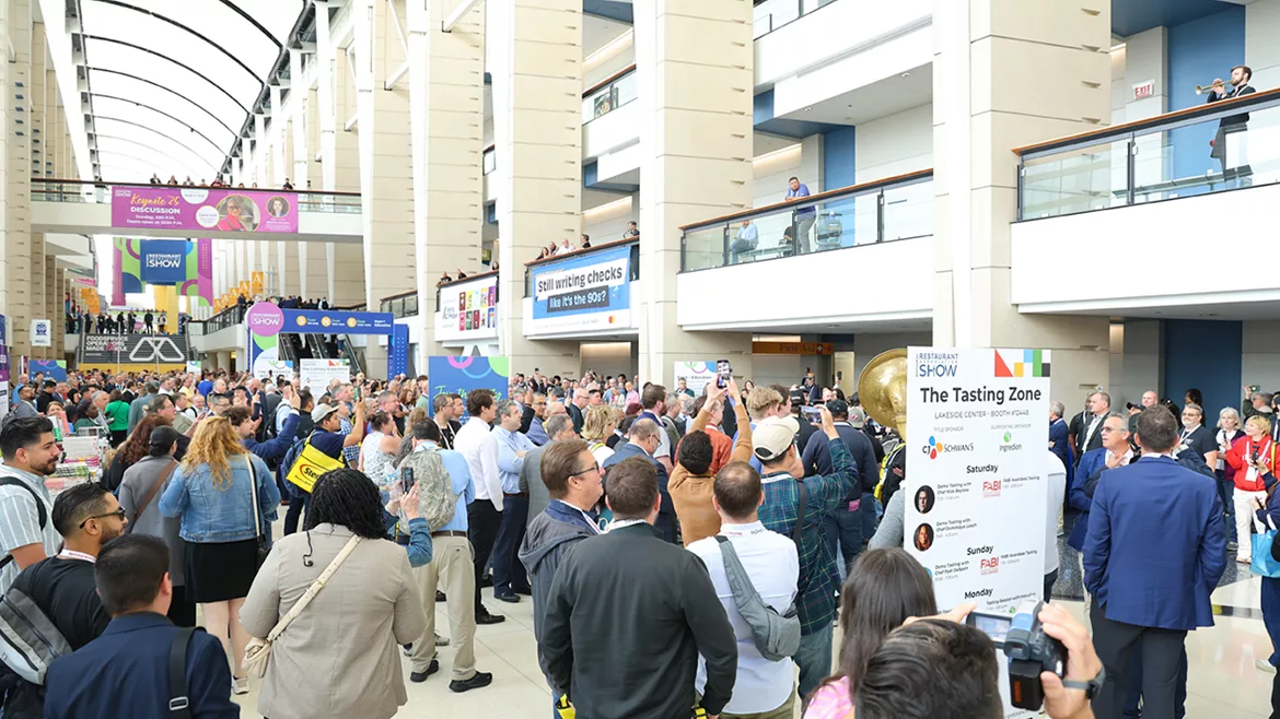 This image shows a large crowd attending a major trade show event.