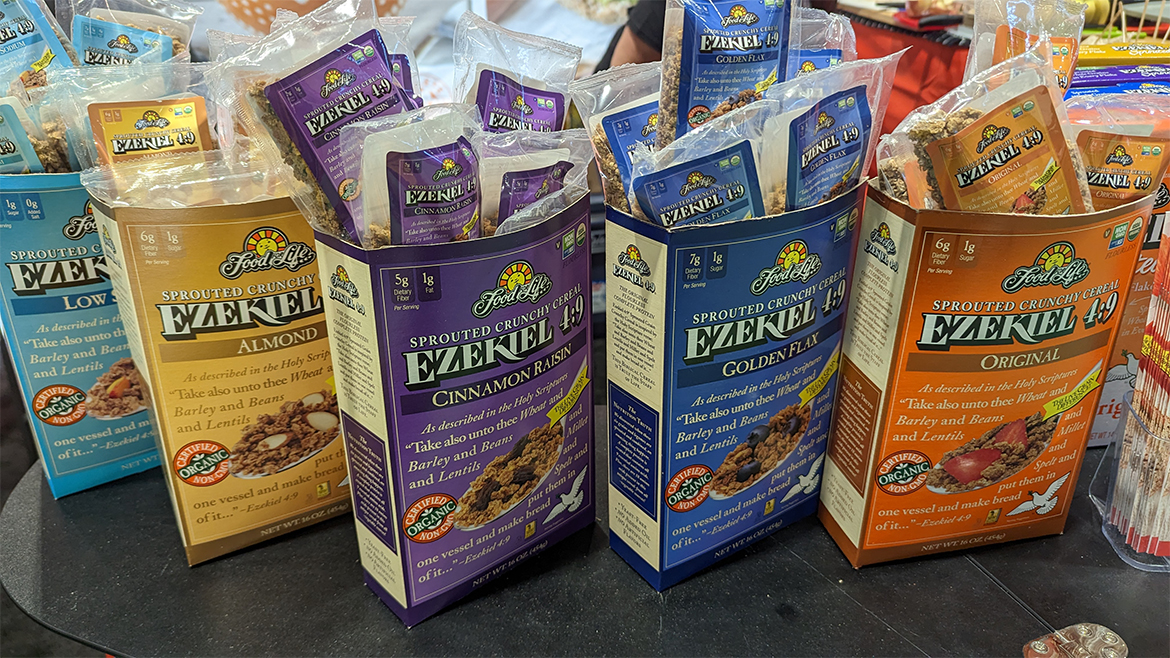 Five Food for Life (Ezekiel 4:9) cereal boxes, in blue, yellow, purple, and orange colors. 