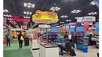 Show floor at the 2025 Sweets & Snacks Expo with Ferrara, Spangler, and Morris banners.