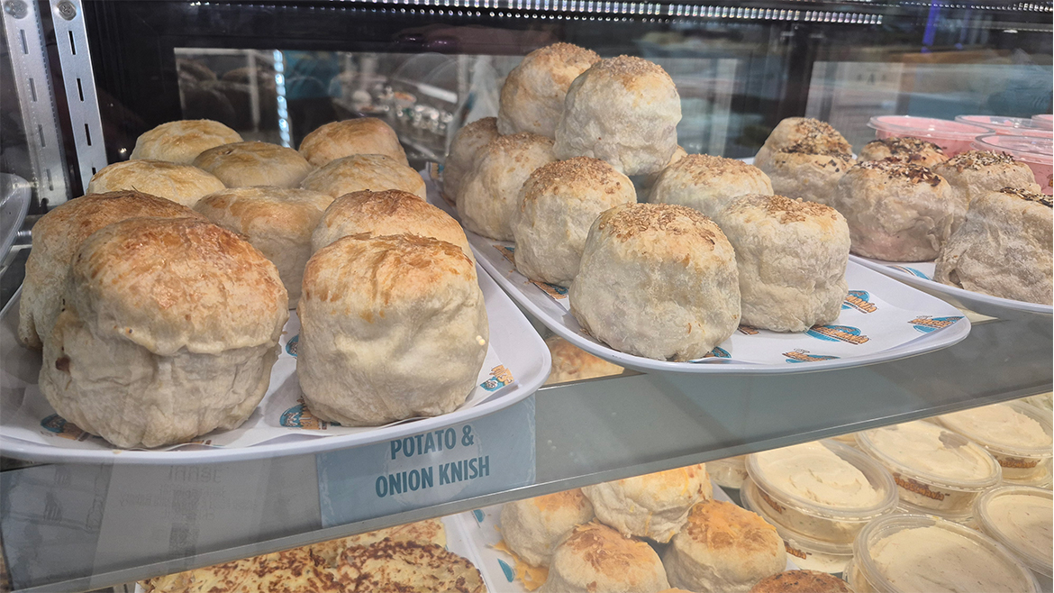 Display case full of assorted knishes