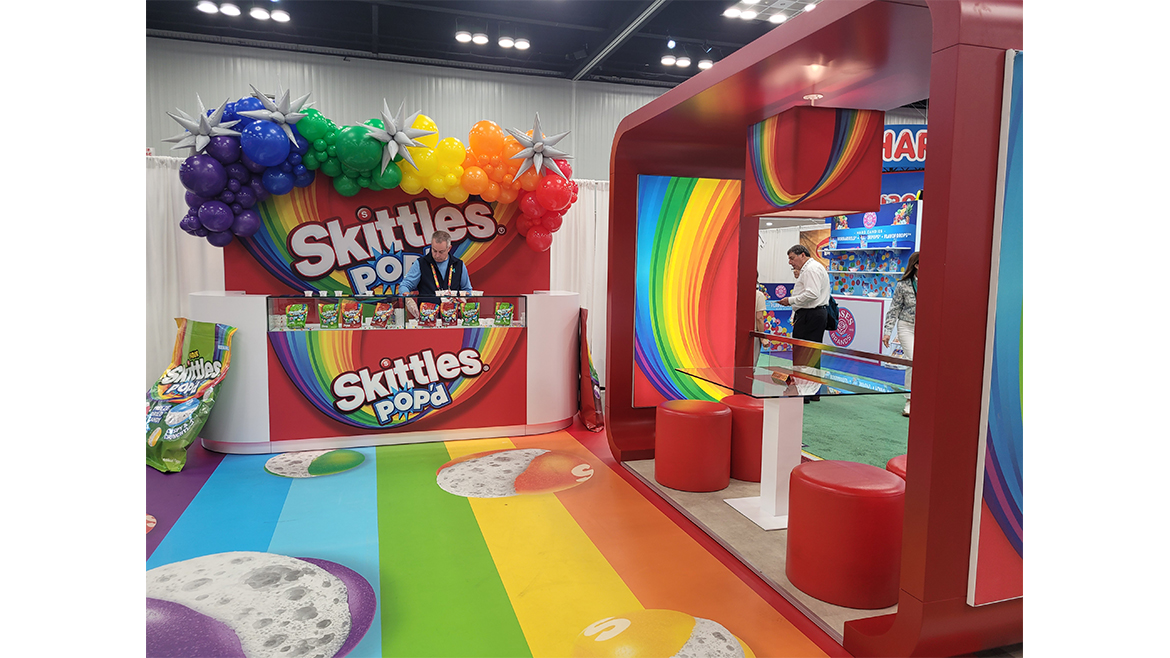 The Skittles Pop’d booth at the 2025 Sweets & Snacks Expo, which is brightly colored.
