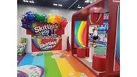 The Skittles Pop’d booth at the 2025 Sweets & Snacks Expo, which is brightly colored. The Skittles Pop’d booth at the 2025 Sweets & Snacks Expo, which is brightly colored.