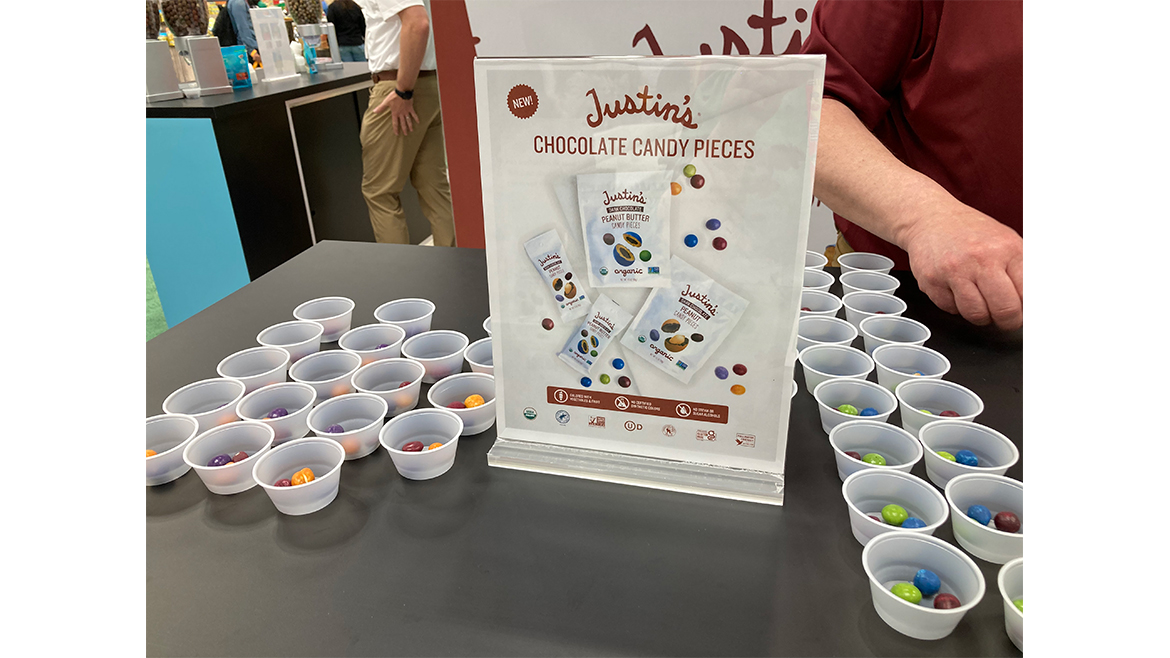 Justin’s Chocolate Candy Pieces being sampled at the 2025 Sweets & Snacks Expo.