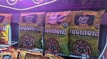 Bags of LesserEvil Moonions snacks at tradeshow booth