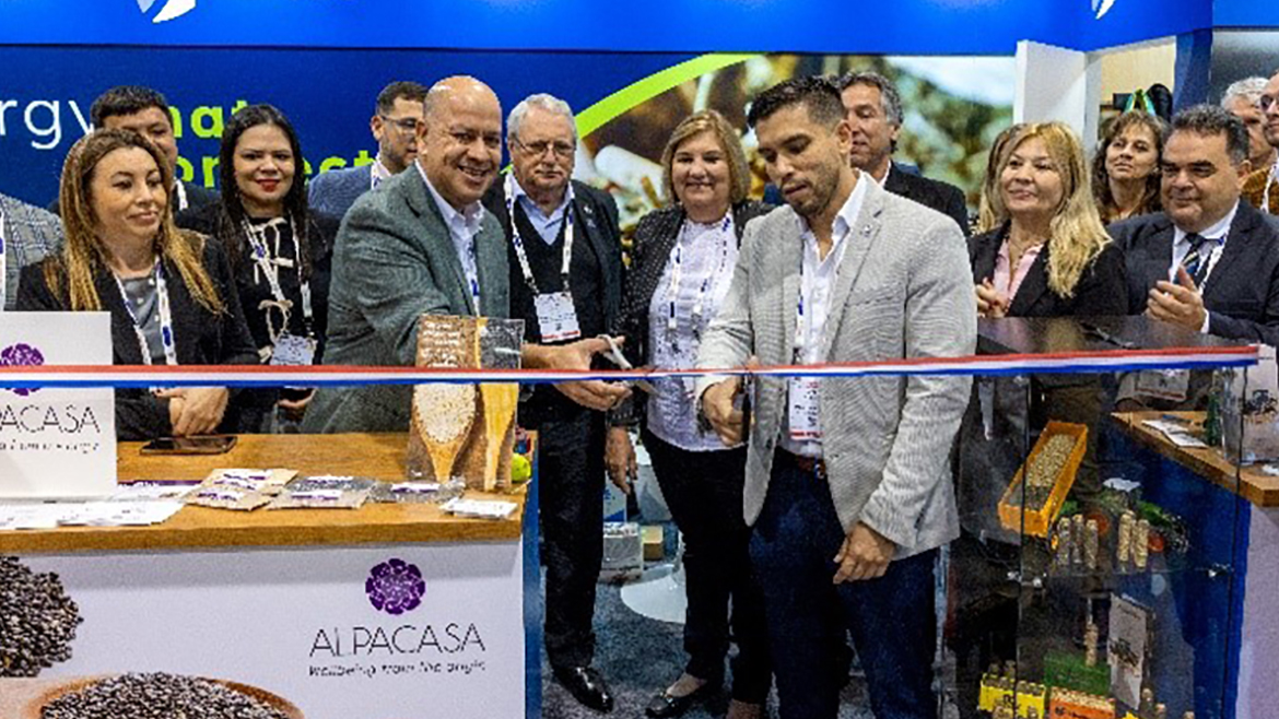 Group of professionals cutting a ribbon at a tradeshow booth