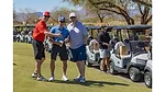 This image shows a moment from a charity golf tournament, highlighting community support and outdoor activity.