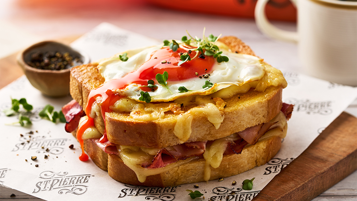 This image features a Croque Madame, a classic French hot sandwich. 