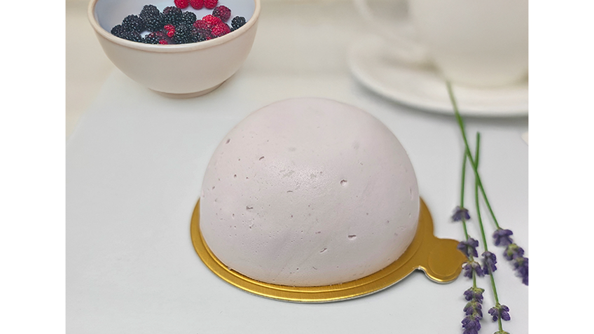 White, dome-shaped dessert on gold plate