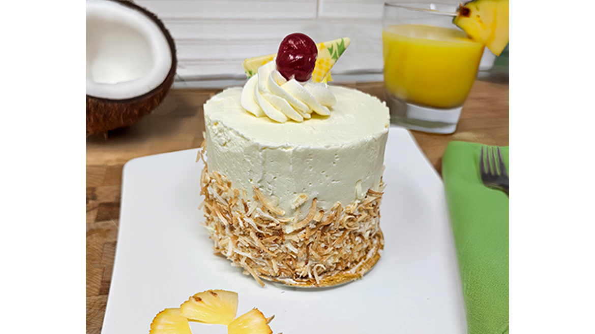 White, dome-shaped dessert on gold plate
