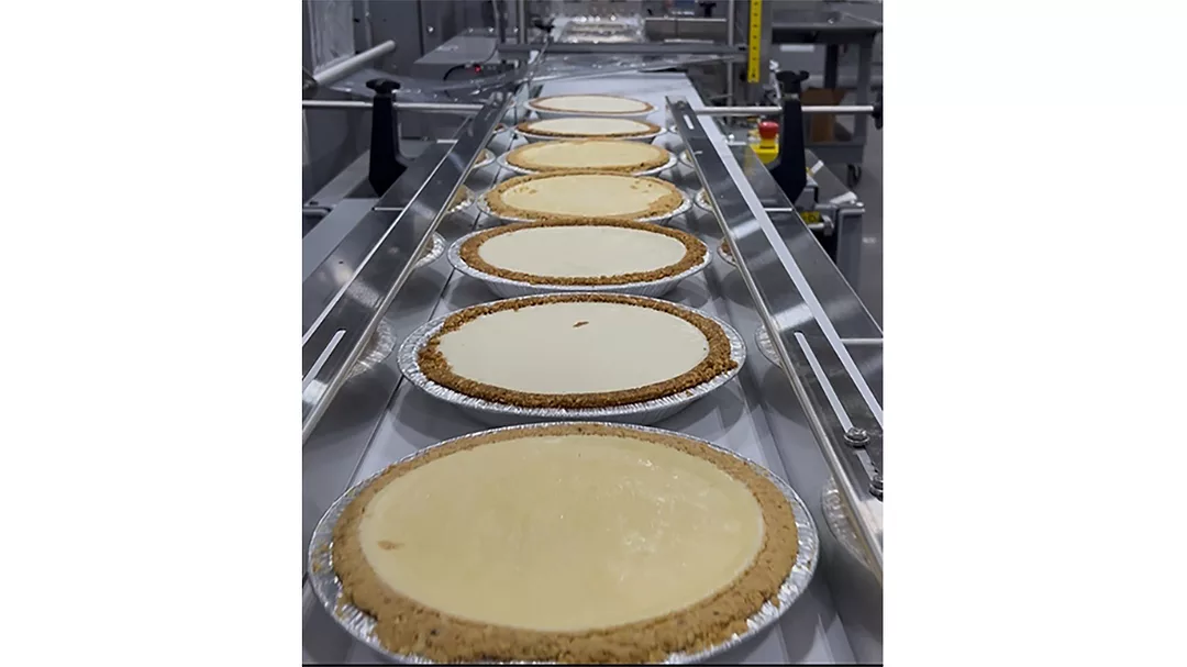 Pies moving through Texwrap packaging system
