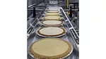 Pies moving through Texwrap packaging system