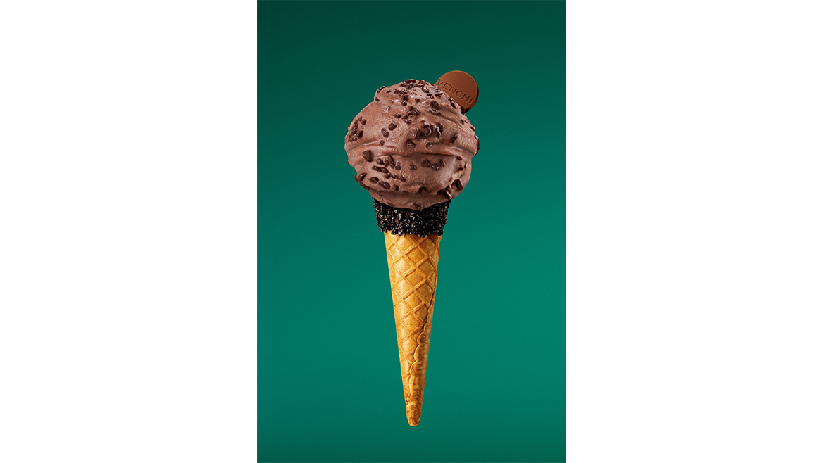 Chocolate gelato cone on green background