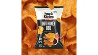 A black and white bag of Smash Kitchen Kettle Cooked Hot Honey BBQ chips, with chips in the background.