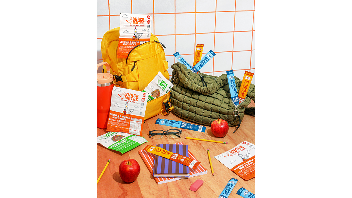 Table with New Primal sticks, apples, and school supplies