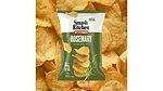 A green and white bag of Smash Kitchen Kettle Cooked Rosemary chips, with chips in the background.