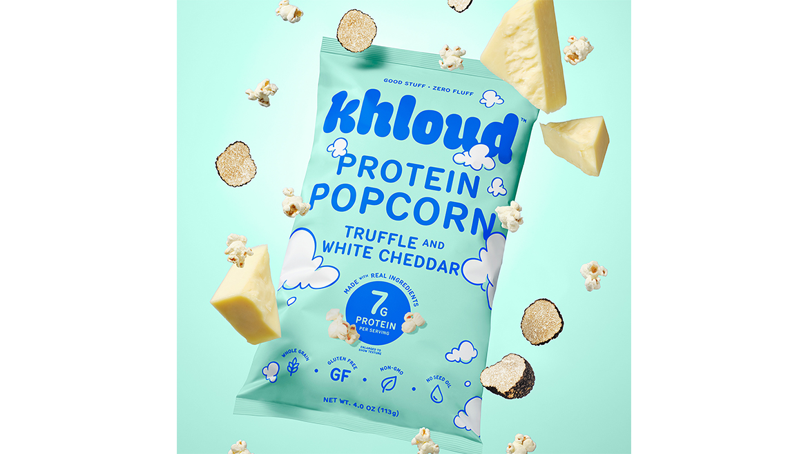 Khloud Truffle and White Cheddar Protein Popcorn is a 4-ounce snack featuring 7g of protein per serving