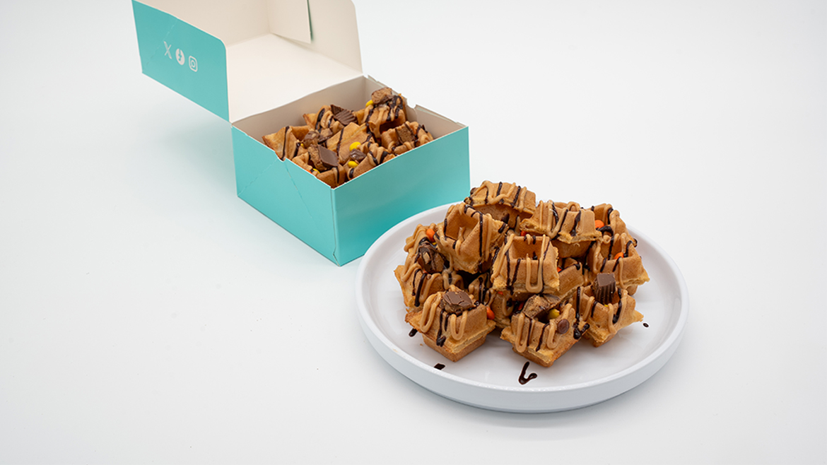 Drizzled waffle pieces on plate and in blue box