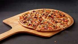 Red Baron’s new Korean BBQ pizza fresh from the oven, cut into slices.