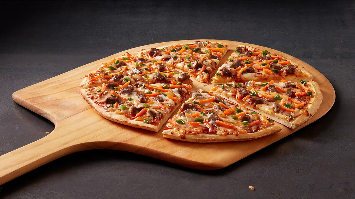 Red Baron’s new Korean BBQ pizza fresh from the oven, cut into slices.