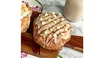 Horchata doughnut on table next to bottle of horchata