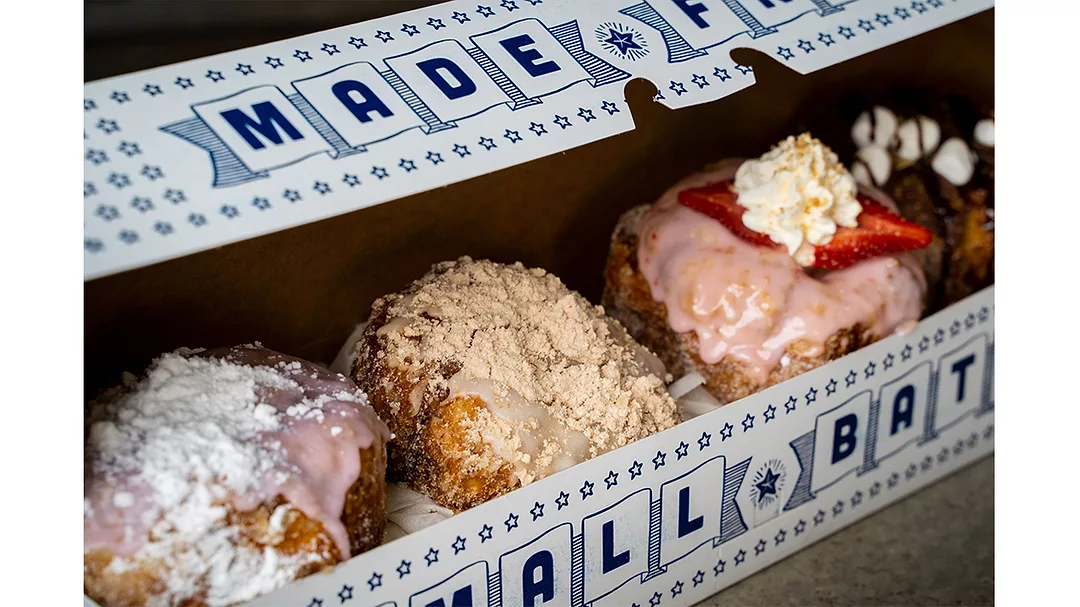 Assorted doughnuts in a narrow white box