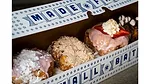 Assorted doughnuts in a narrow white box