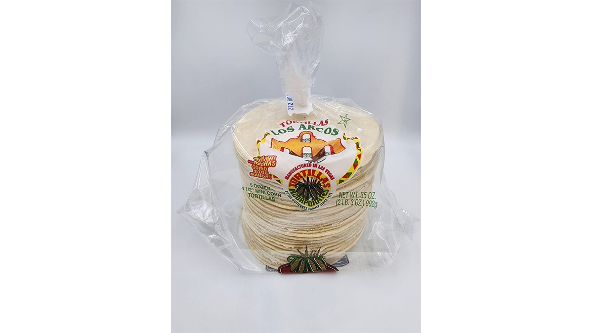 Package of white Los Arcos corn tortillas on white background