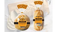 Two loaves of bread, one more round and one more long/rectangular, both in packaging. Two loaves of bread, one more round and one more long/rectangular, both in packaging.
