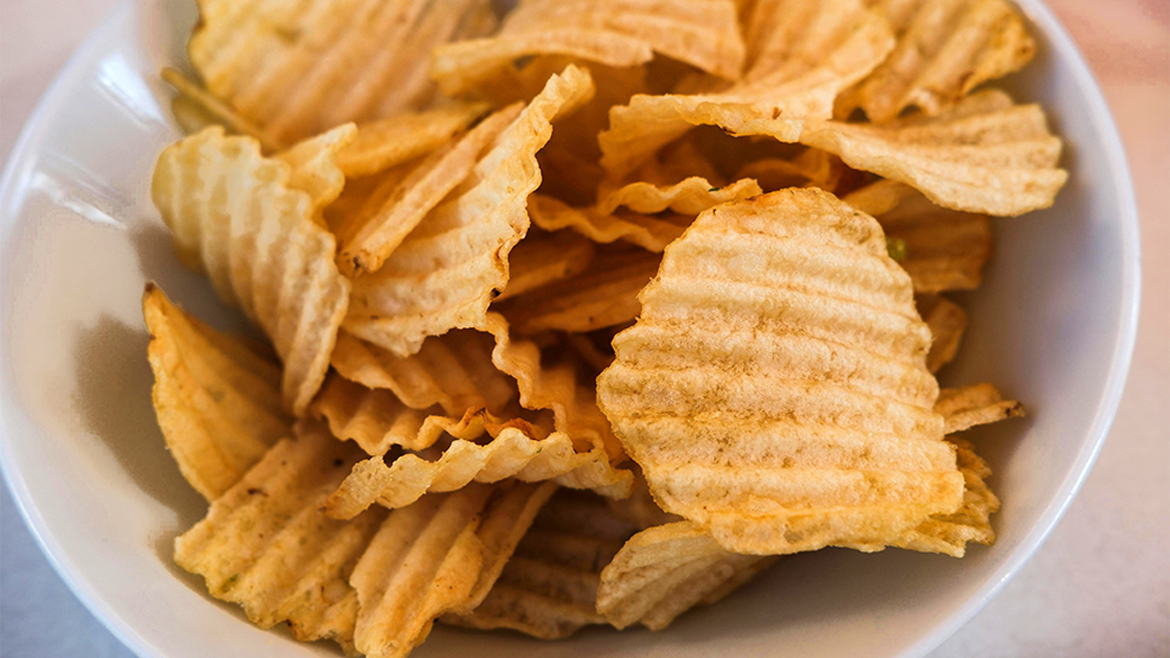 White bowl full of potato chips