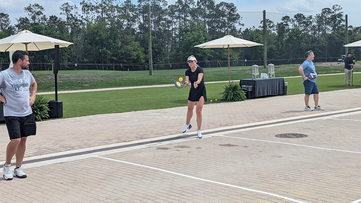 ABA Convention 2025 attendees play pickleball on a court.
