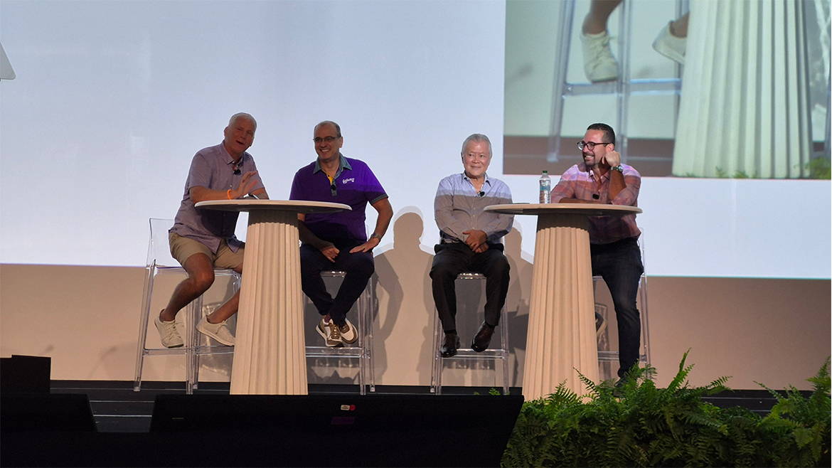 Four men sit on a stage giving a panel talk at BEMA 2025.