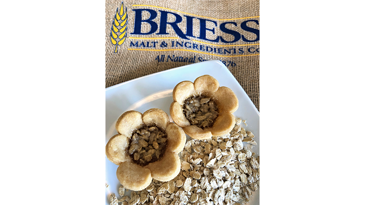 Two flower-shaped oat pies on oat-topped plate