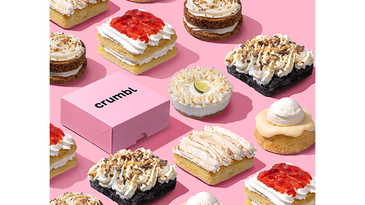 Assorted Crumbl desserts on pink background