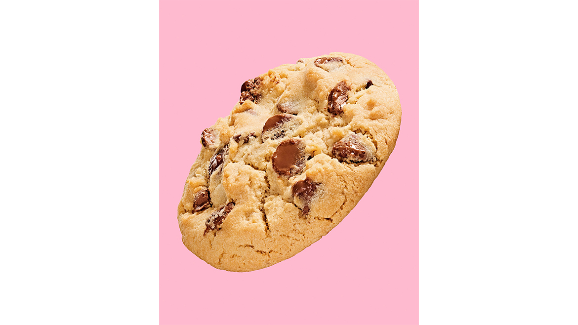 Crumbl Milk Chocolate Chip cookie over pink background