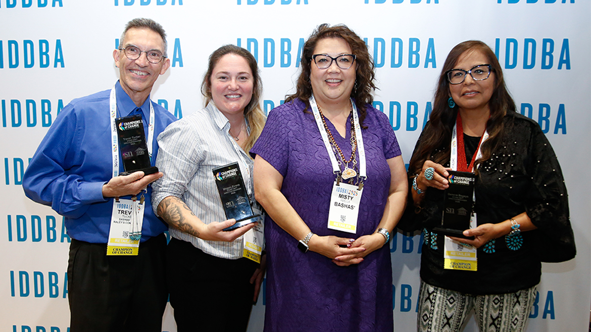 Four people holding awards at IDDBA