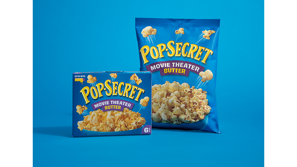 A blue box and a blue bag of Pop Secret movie theater butter popcorn.